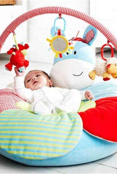 Infant enjoying on a colorful Baby Inflatable Play Mat with engaging toys for sensory development.