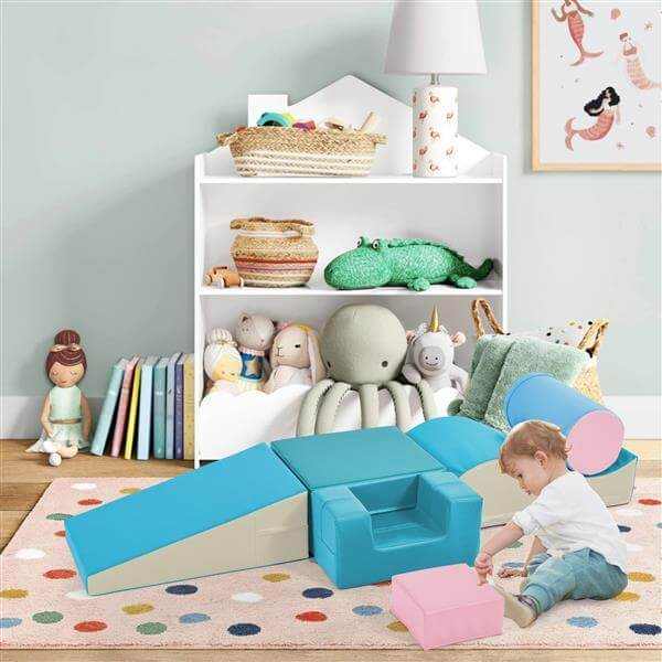 Child playing with colourful soft climbing foam playset in a vibrant playroom, enhancing active fun and coordination.
