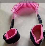 Pink child safety wristband with coil design, designed to keep kids close while exploring crowded places.