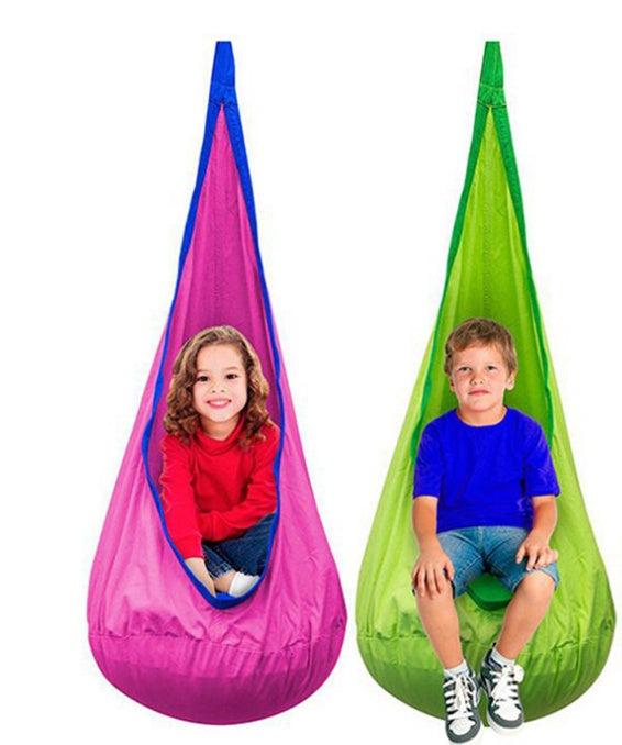 Two kids in colorful sensory swing pods, one pink and one green, showcasing comfort and relaxation.
