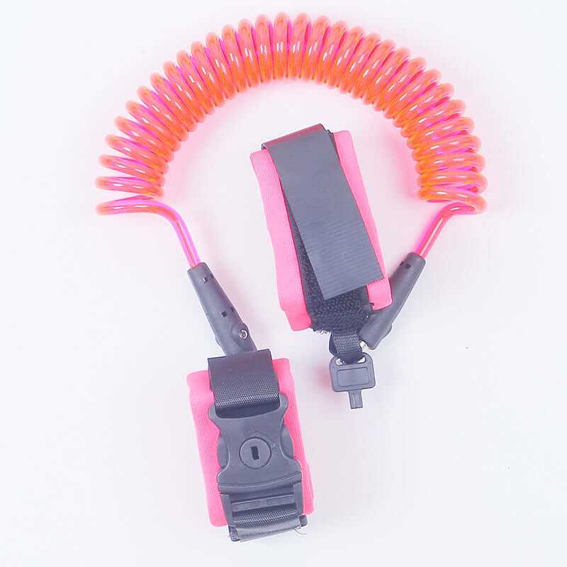 Child safety wristband in pink with coiled strap for secure anti-lost harness, perfect for kids in crowded places.