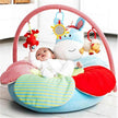 Baby playing on a colorful inflatable play mat with hanging toys, promoting sensory development and safety.