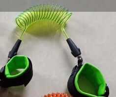 Green Child Safety Wristband with coiled anti-lost wrist leash for kids, providing secure and adjustable fit.
