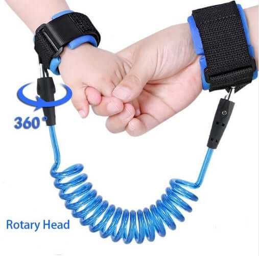 Child safety wristband with adjustable blue harness attached to child, featuring a coiled anti-lost design for secure exploration.