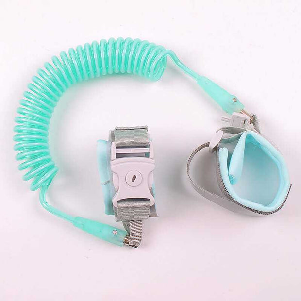 Child safety wristband with coiled leash and adjustable wrist harness for kids, ideal for preventing loss in crowded places.